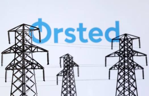 Electric power transmission pylon miniatures and Orsted logo are seen in this illustration taken, December 9, 2022.