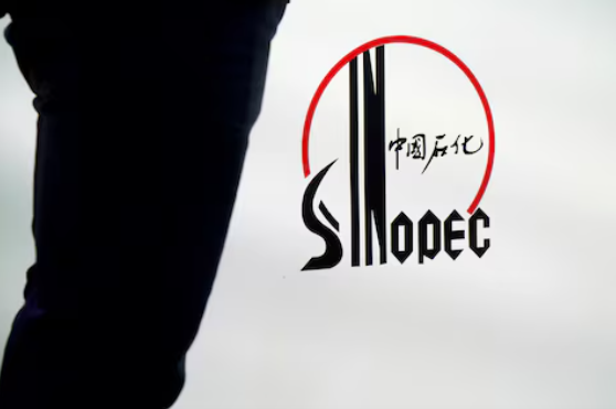 2018年9月19日，上海，一名男子站在中国石油化工集团公司(中石化)的标识旁